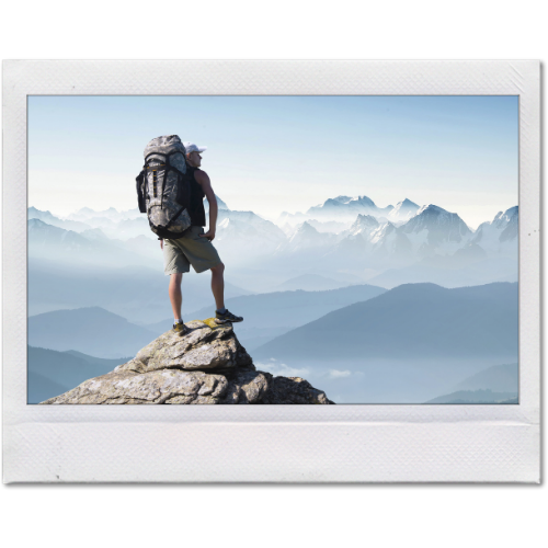 Picture of a man on a mountain peak covered by life insurance.